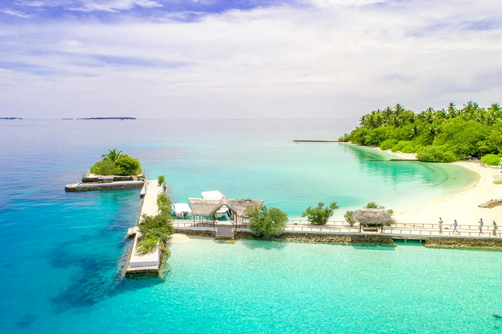 Aerial view of a Maldivian atoll with turquoise lagoon and white beach
