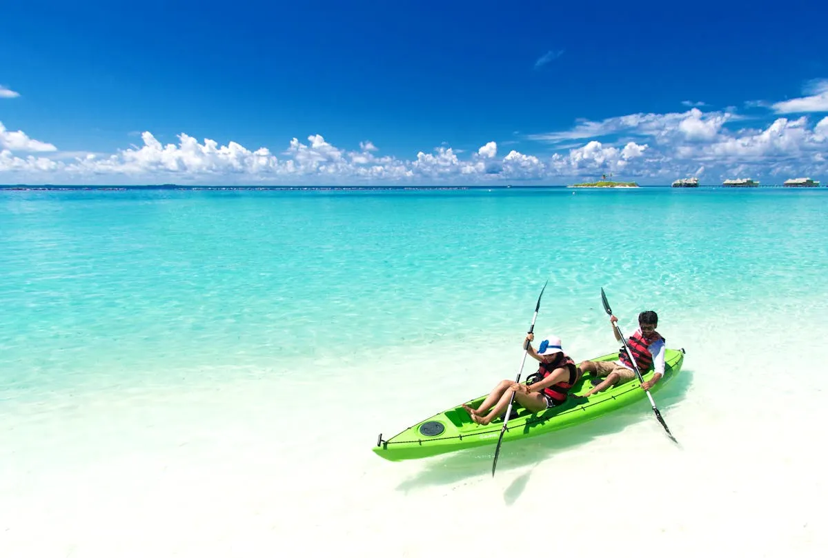 Two people kayaking in clear tropical waters